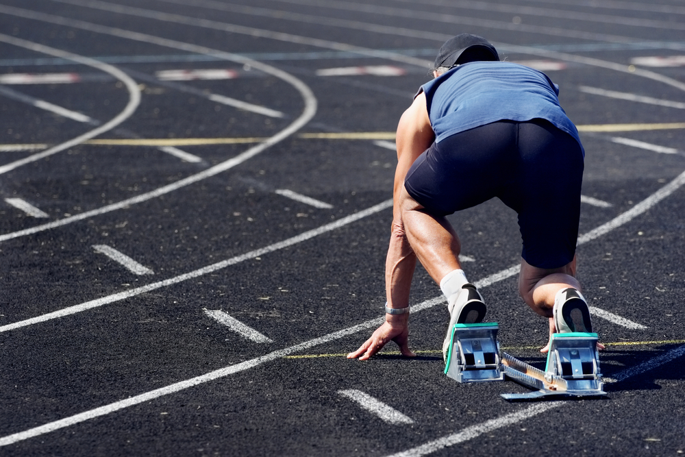 Male masters athlete sprinting