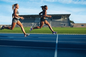 Two women sprinting on a track
