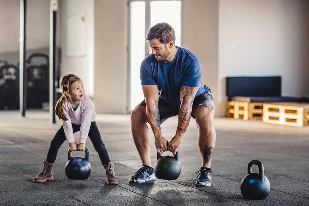 father and daughter weight lifting
