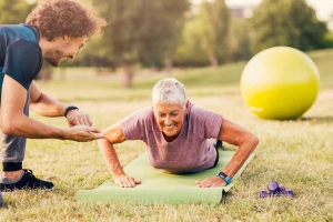 mature woman working out with trainer