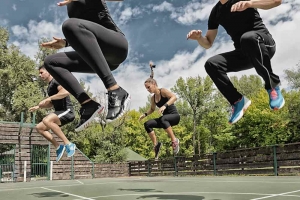 Group of people jumping on a tennis court