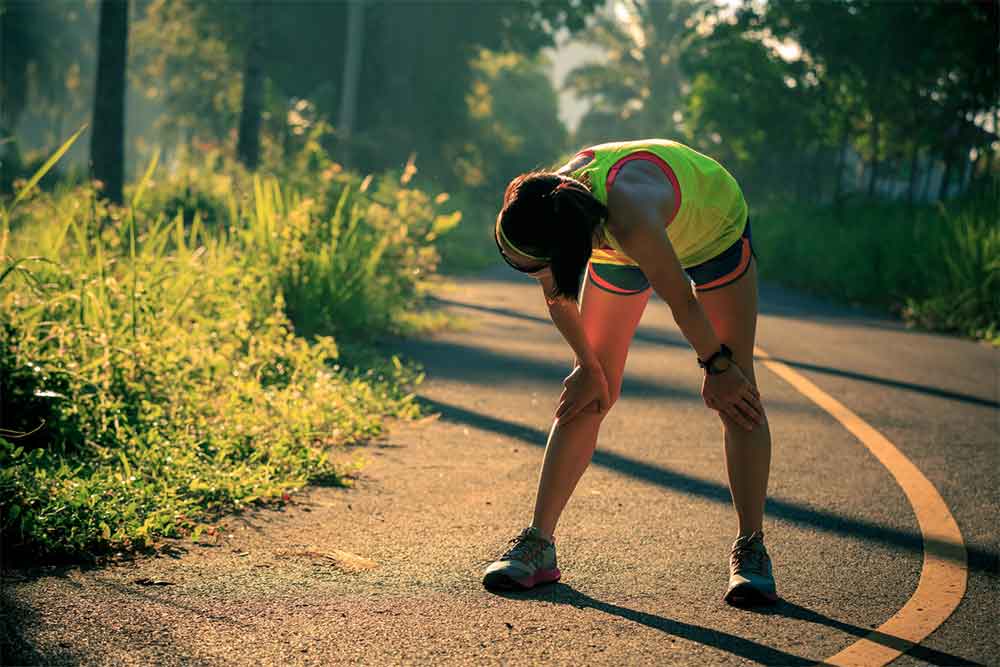 women bent over after running
