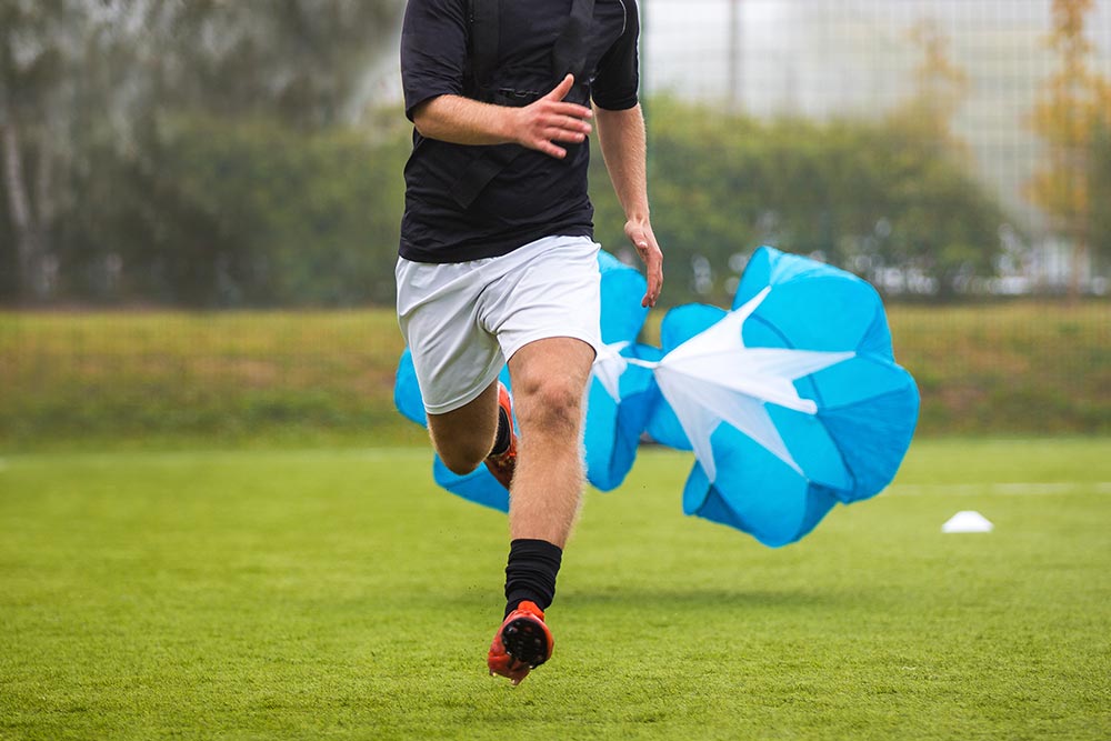 man running with a parachute