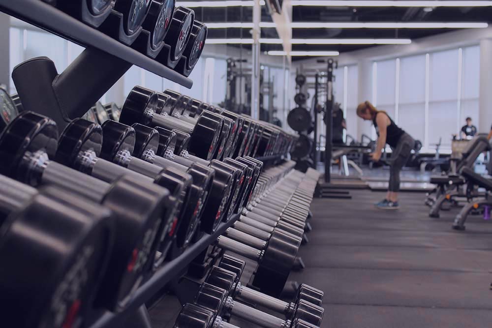 Woman lifting weights in a gym