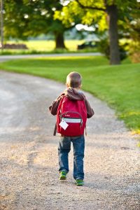Boy walking to school with backpack
