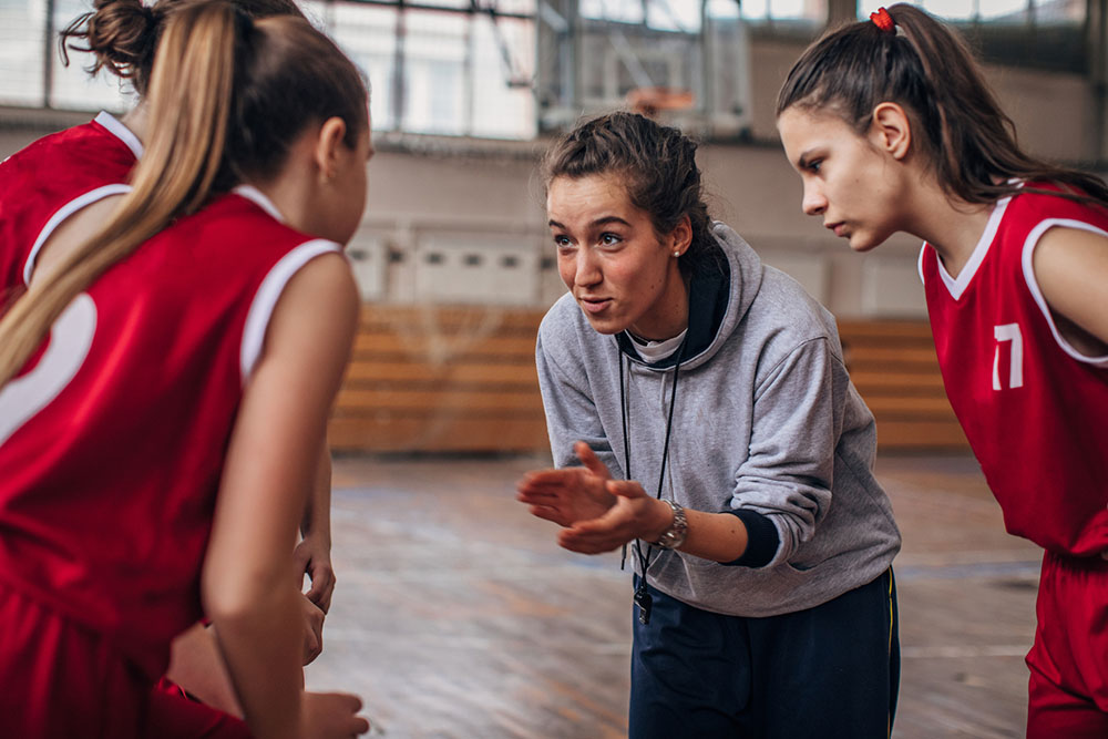 Female coach coaching basketball team