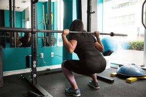Female athlete back squatting