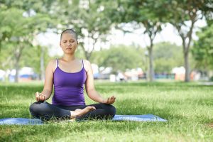 Cancer patient doing yoga in the park